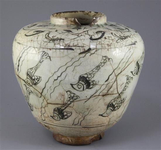 A Kashan pottery ovoid jar, 13th century, height 21.5cm, cracks and losses